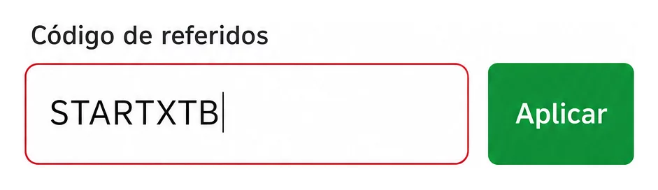 Formulario de XTB con el campo del código de referidos abierto y STARTXTB ingresado, junto al botón Aplicar